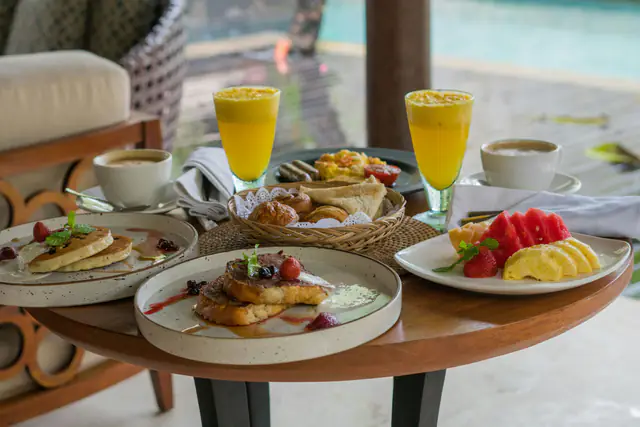Breakfast with fresh mango juice on a villa terrace